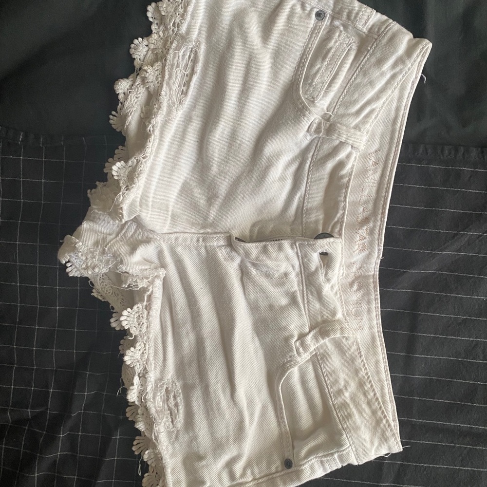 White embroidered distressed shorts